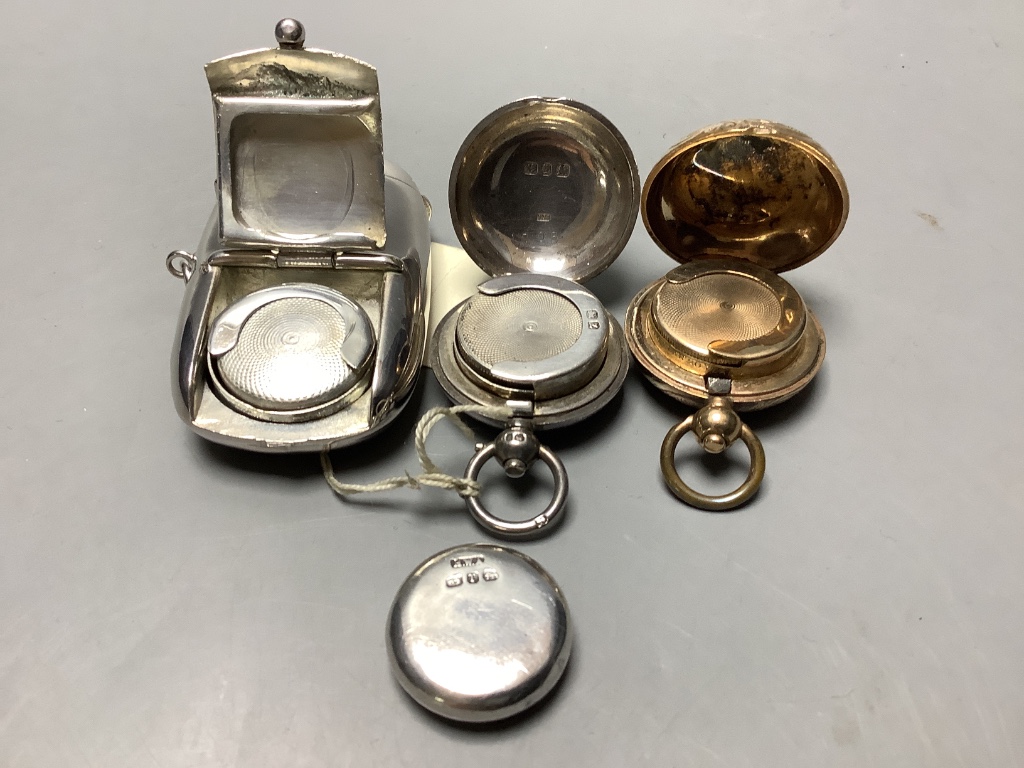 A late Victorian silver sovereign case, a gold plated sovereign case, a plated sovereign/vesta case and a compass.
